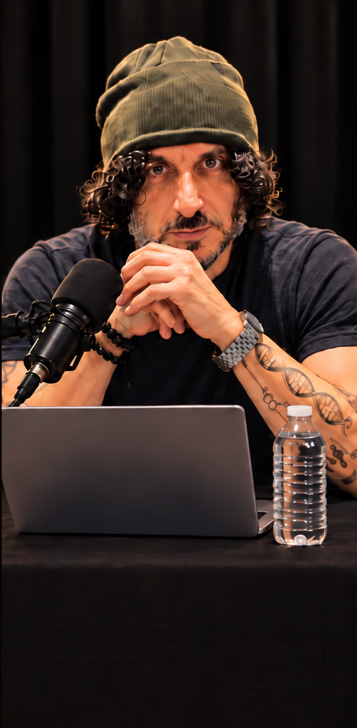 Al Gord, ADHD and attachment coach, seated with hands clasped behind a podcast microphone and laptop